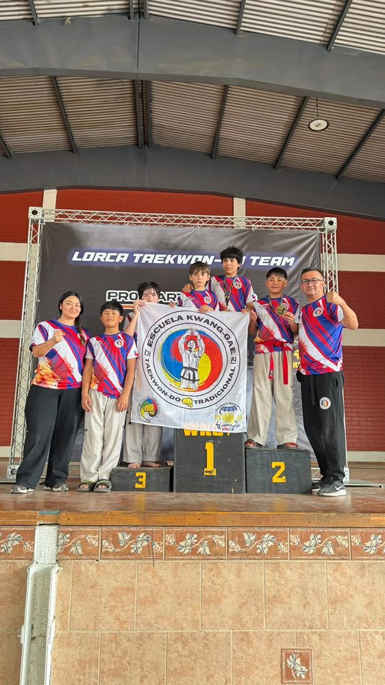 Alumnos de la Escuela Kwang-Gae en el podio de una competencia con sus medallas